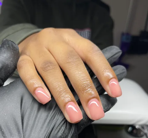 Short natural nails finished with a glossy soft-pink overlay by Leah